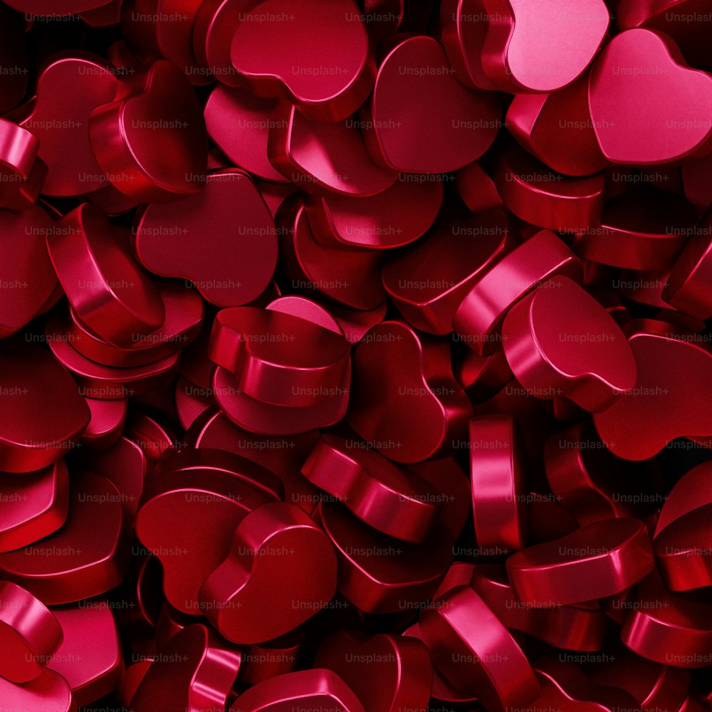 a large pile of red heart shaped objects