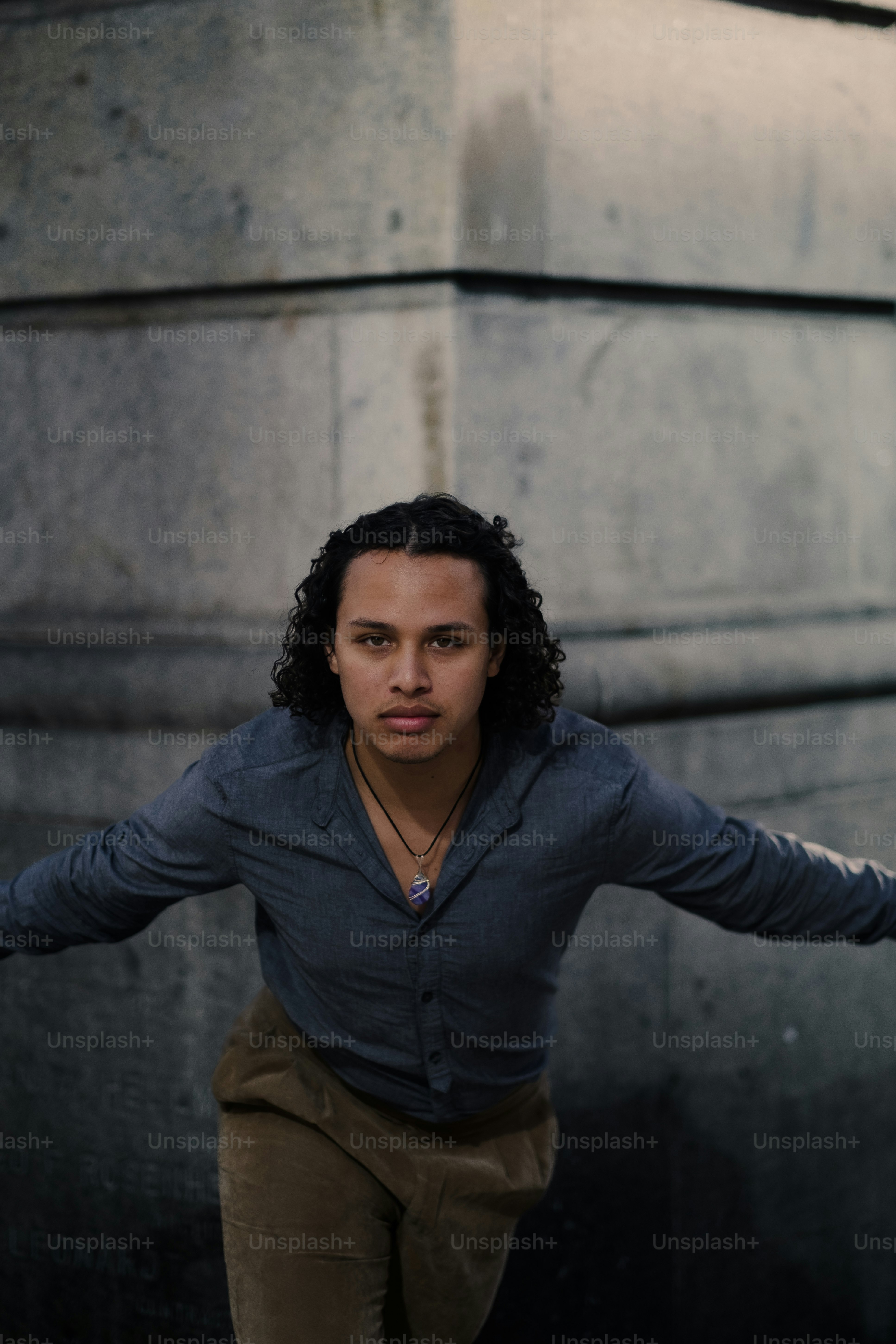a man standing in front of a tall building