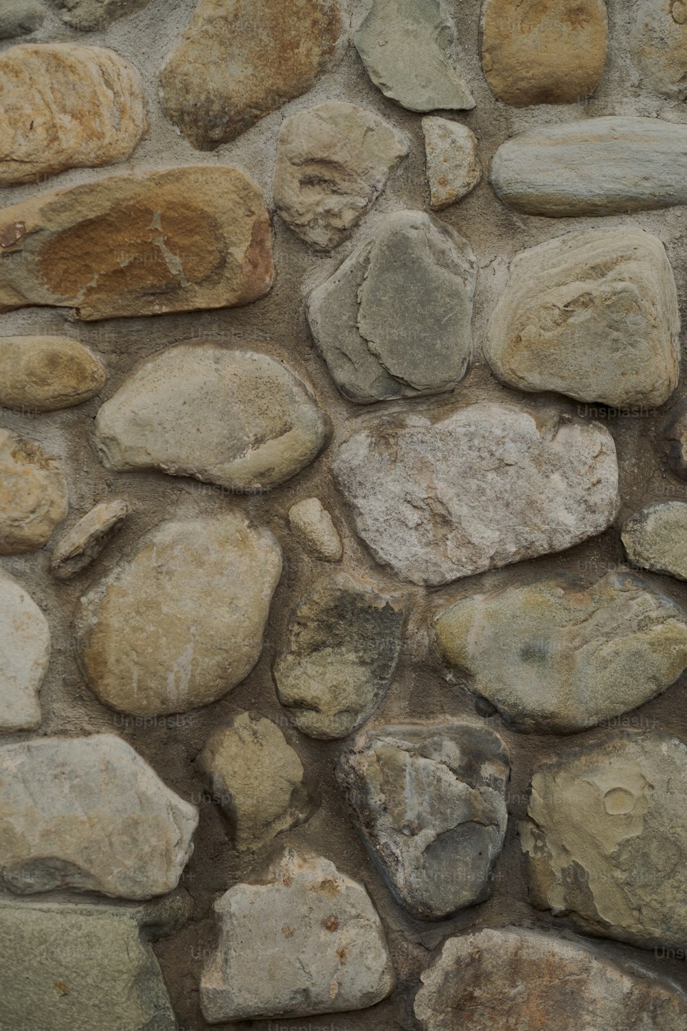 a close up of a stone wall with rocks