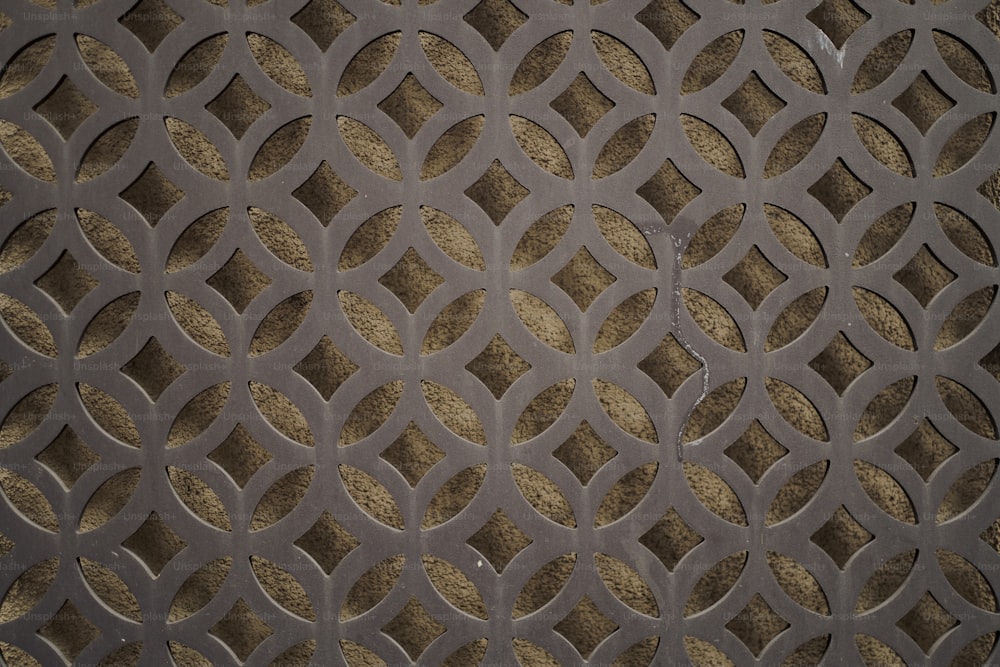 a close up of a metal grate with circles on it