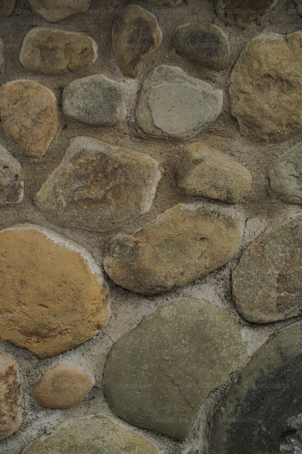 a close up of a stone wall with rocks