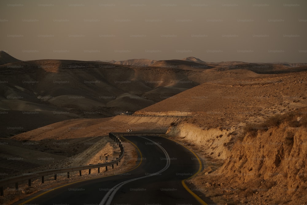 a winding road in the middle of a desert