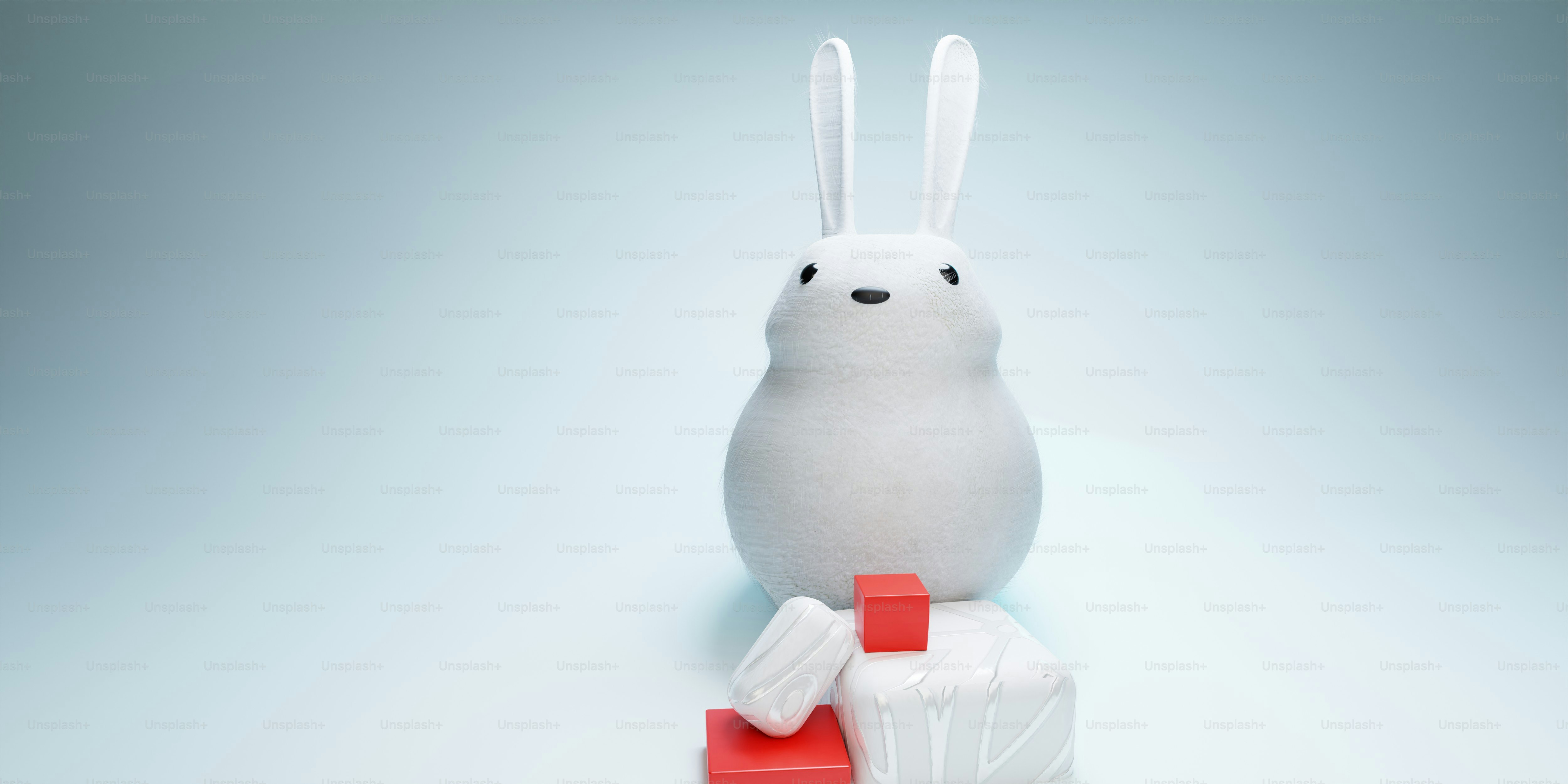 A white stuffed animal sitting on top of a red block photo – Rabbit ...