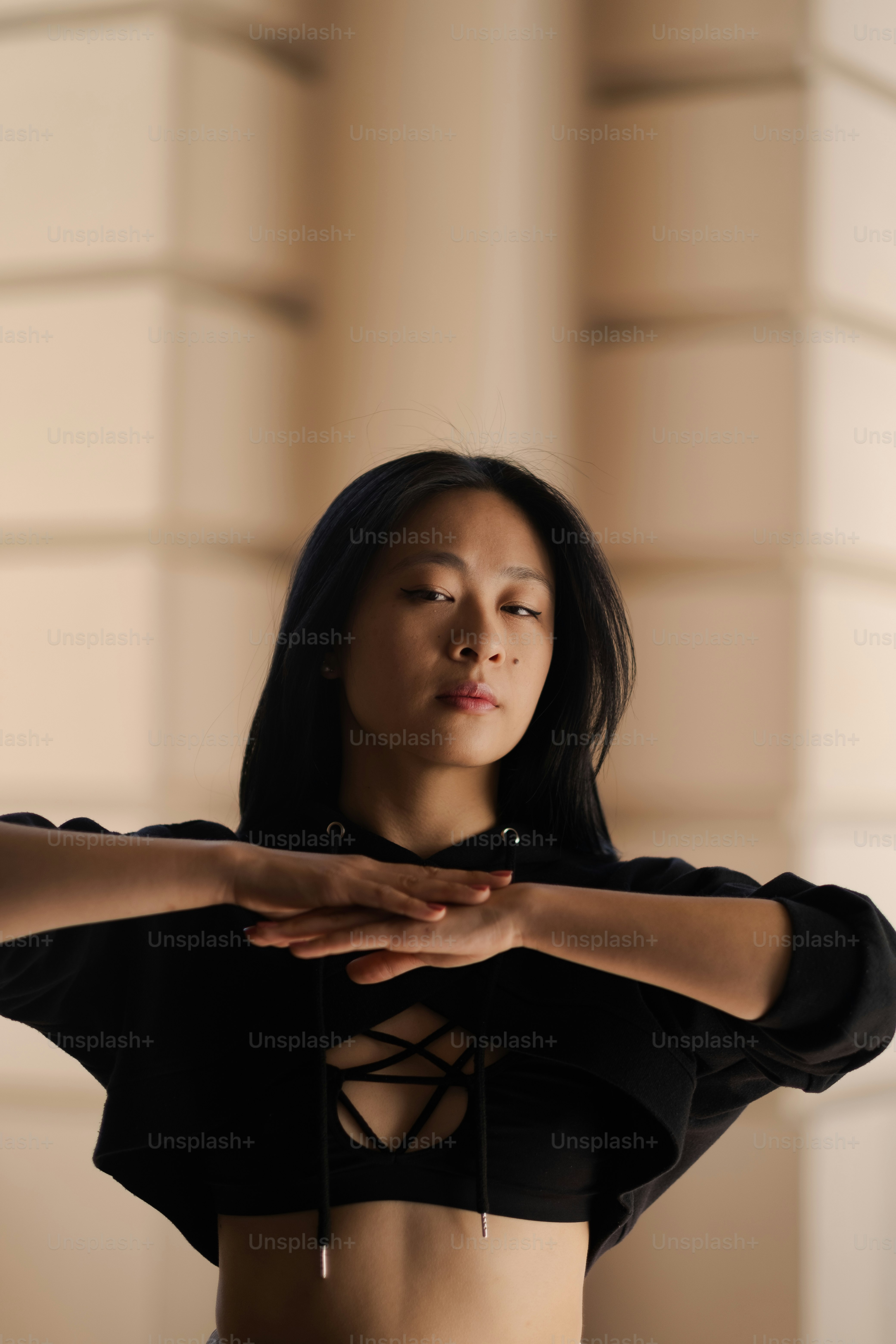 a woman in a black top holding her hands together