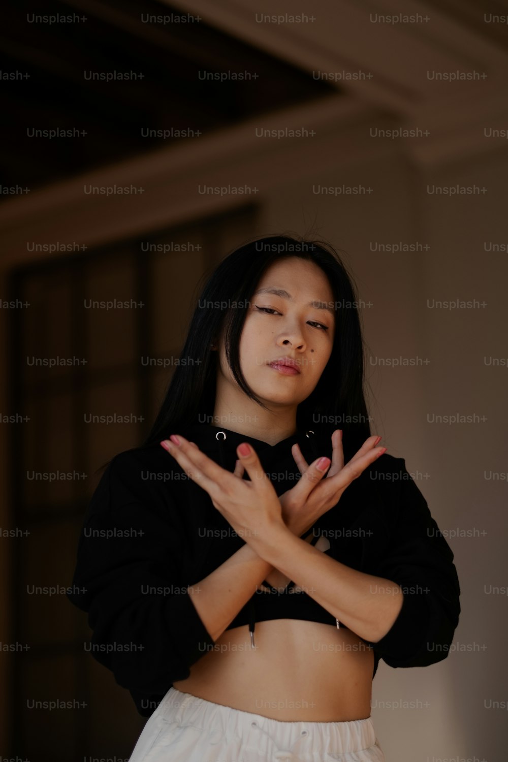 a woman in a black shirt and white skirt