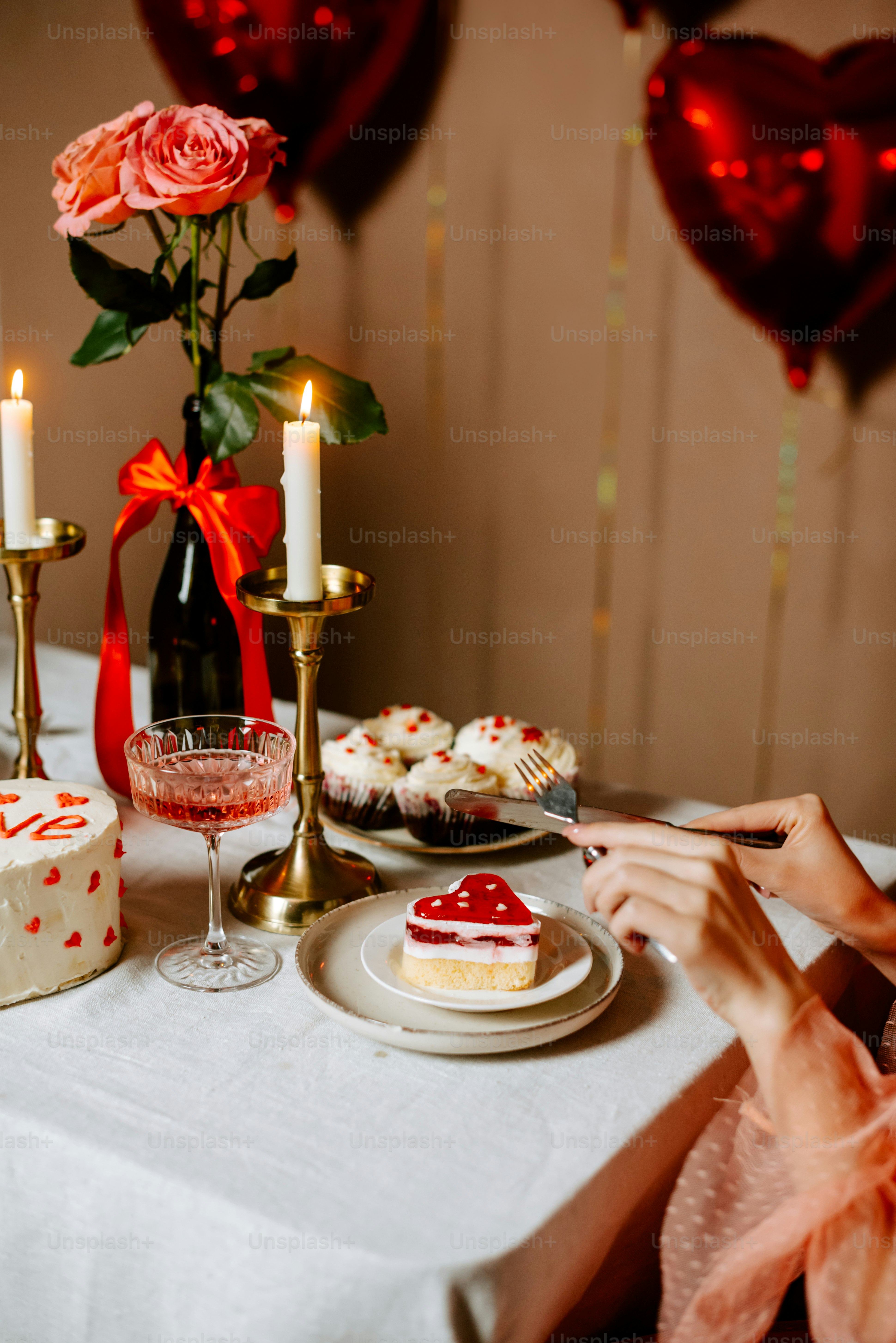 a woman sitting at a table with a plate of cake