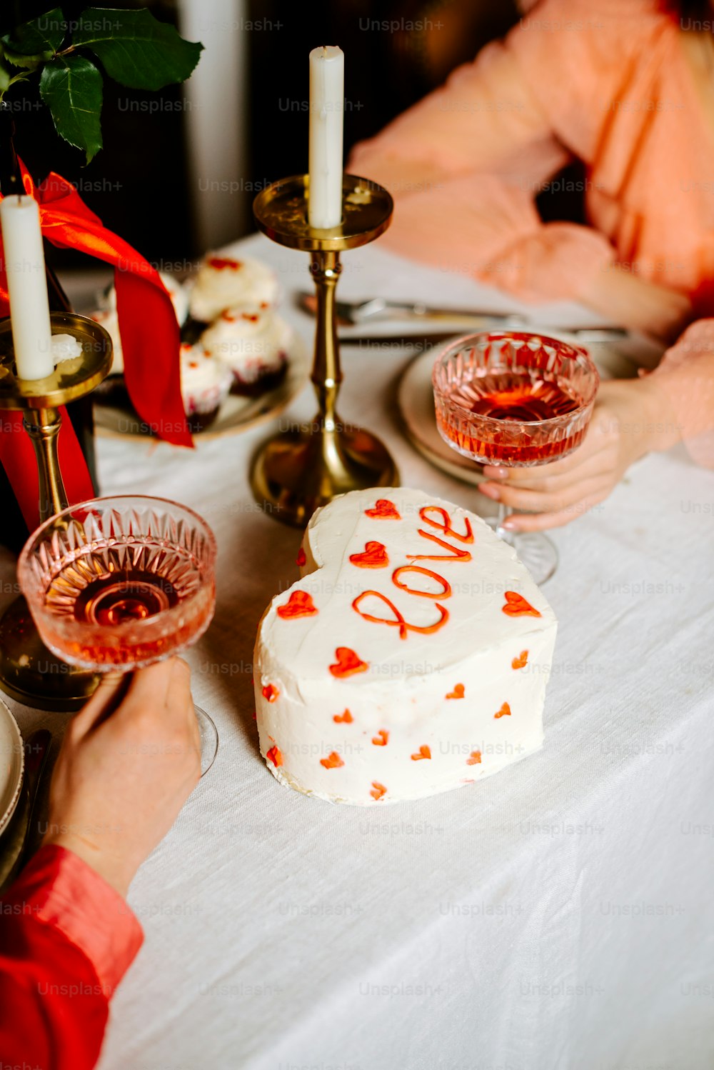 a table topped with a cake and two candles