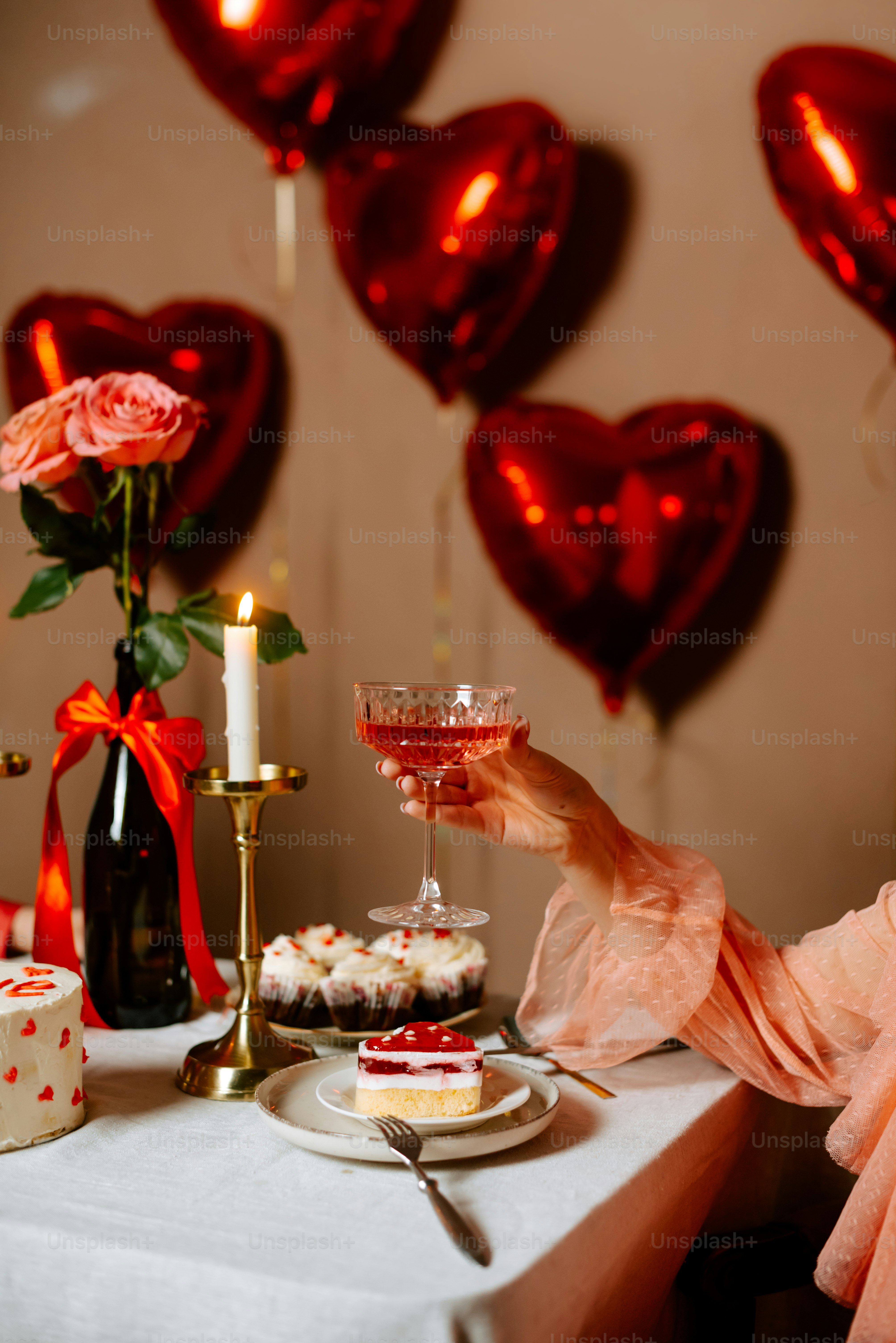 a woman sitting at a table holding a wine glass