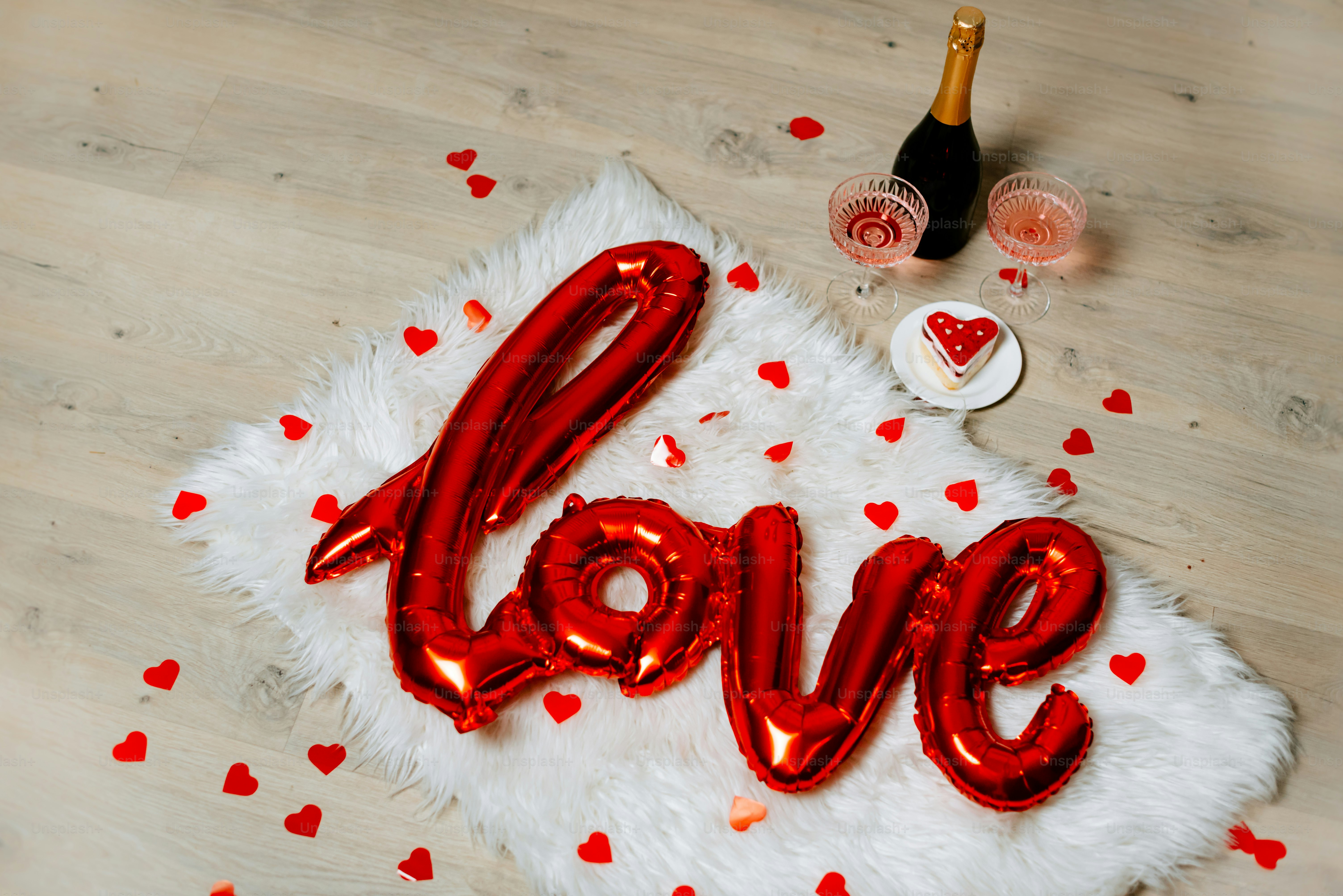a red love balloon sitting on top of a white rug