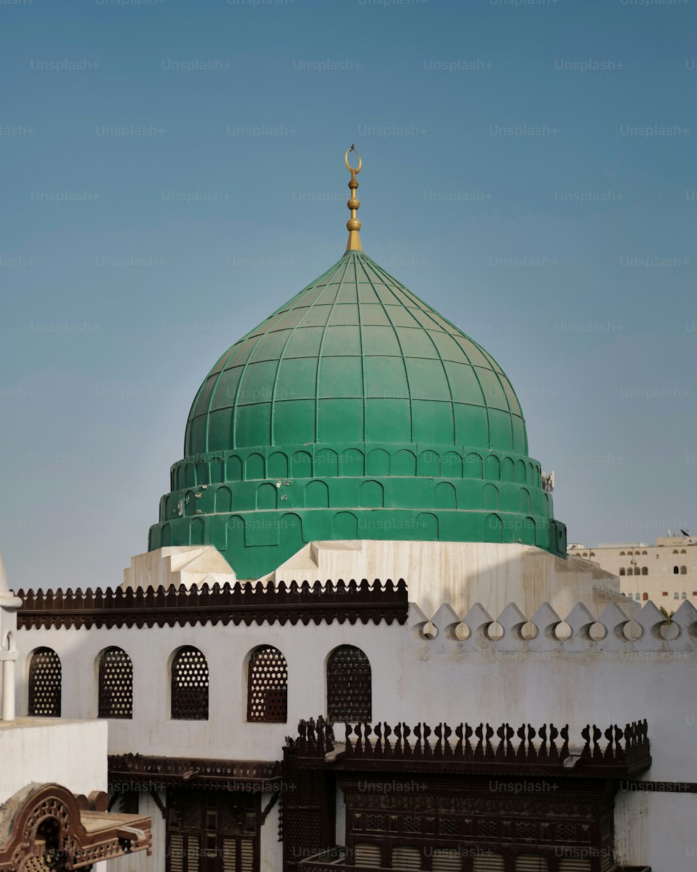 a green dome on top of a white building