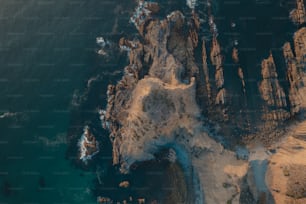 an aerial view of a rocky coastline near the ocean