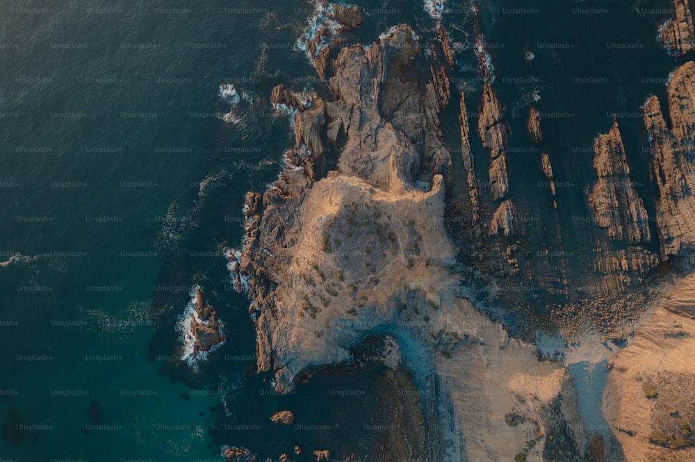 an aerial view of a rocky coastline near the ocean