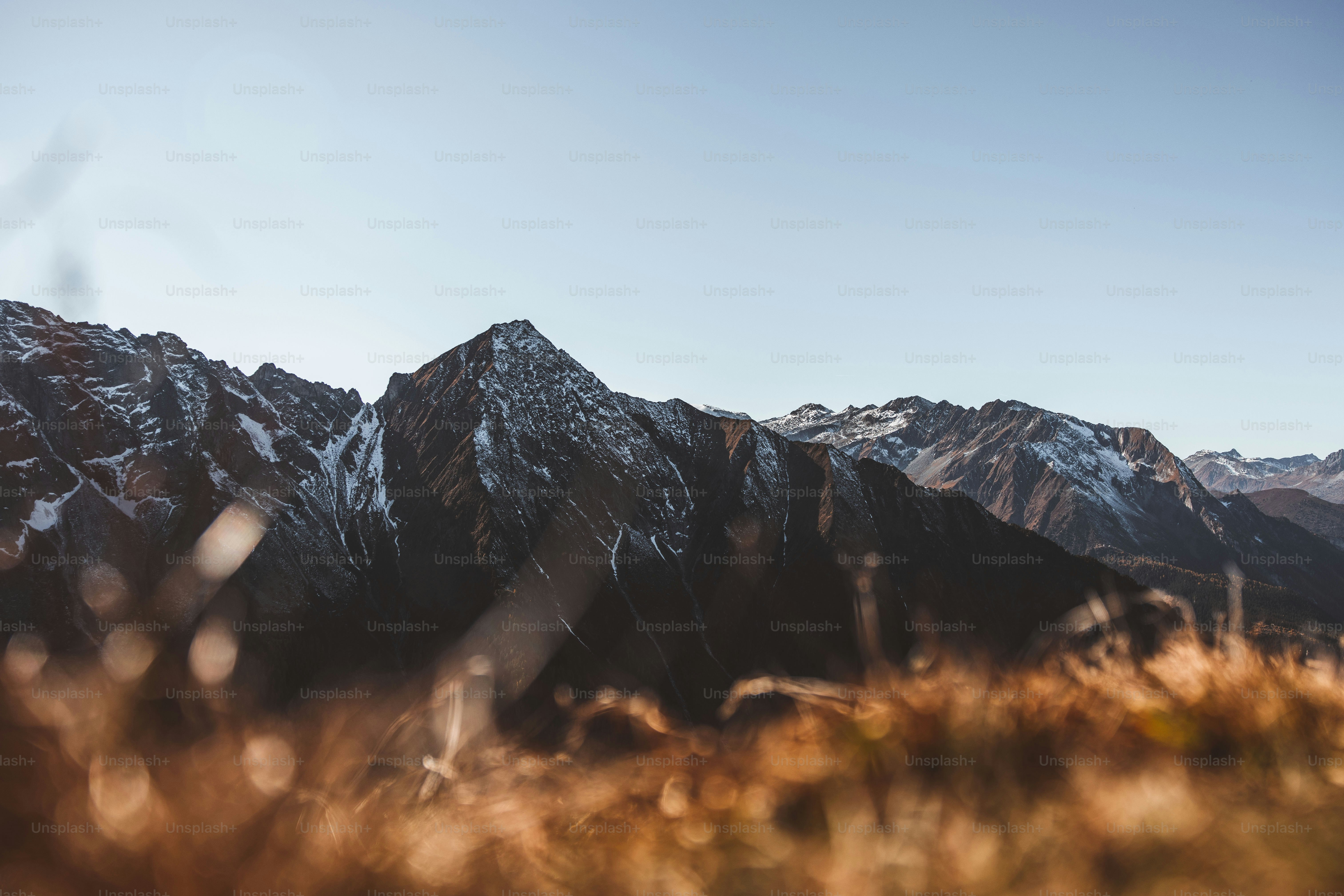 a view of a mountain range from the top of a hill