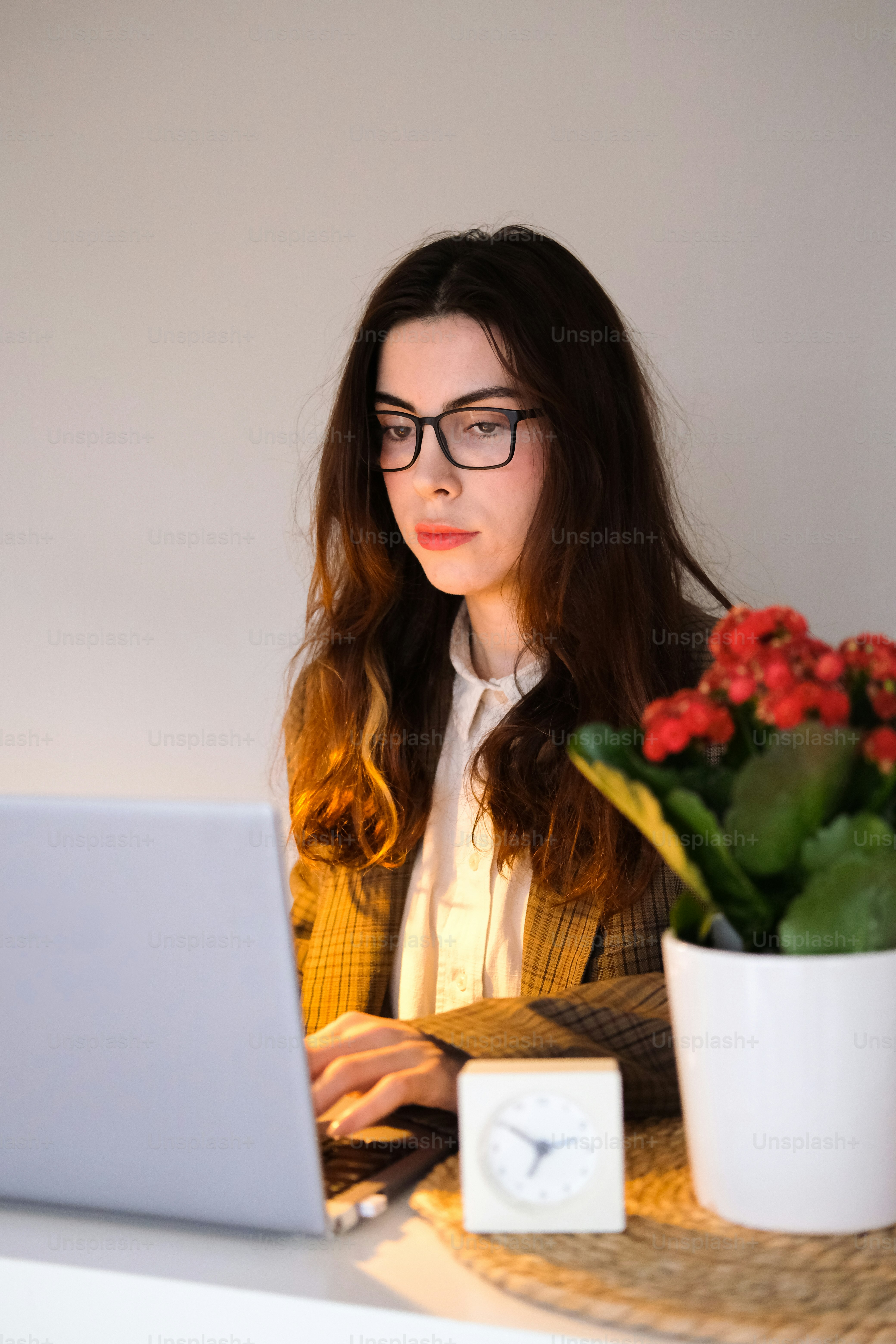 A woman sitting at a desk using a laptop computer photo – Adult Image ...