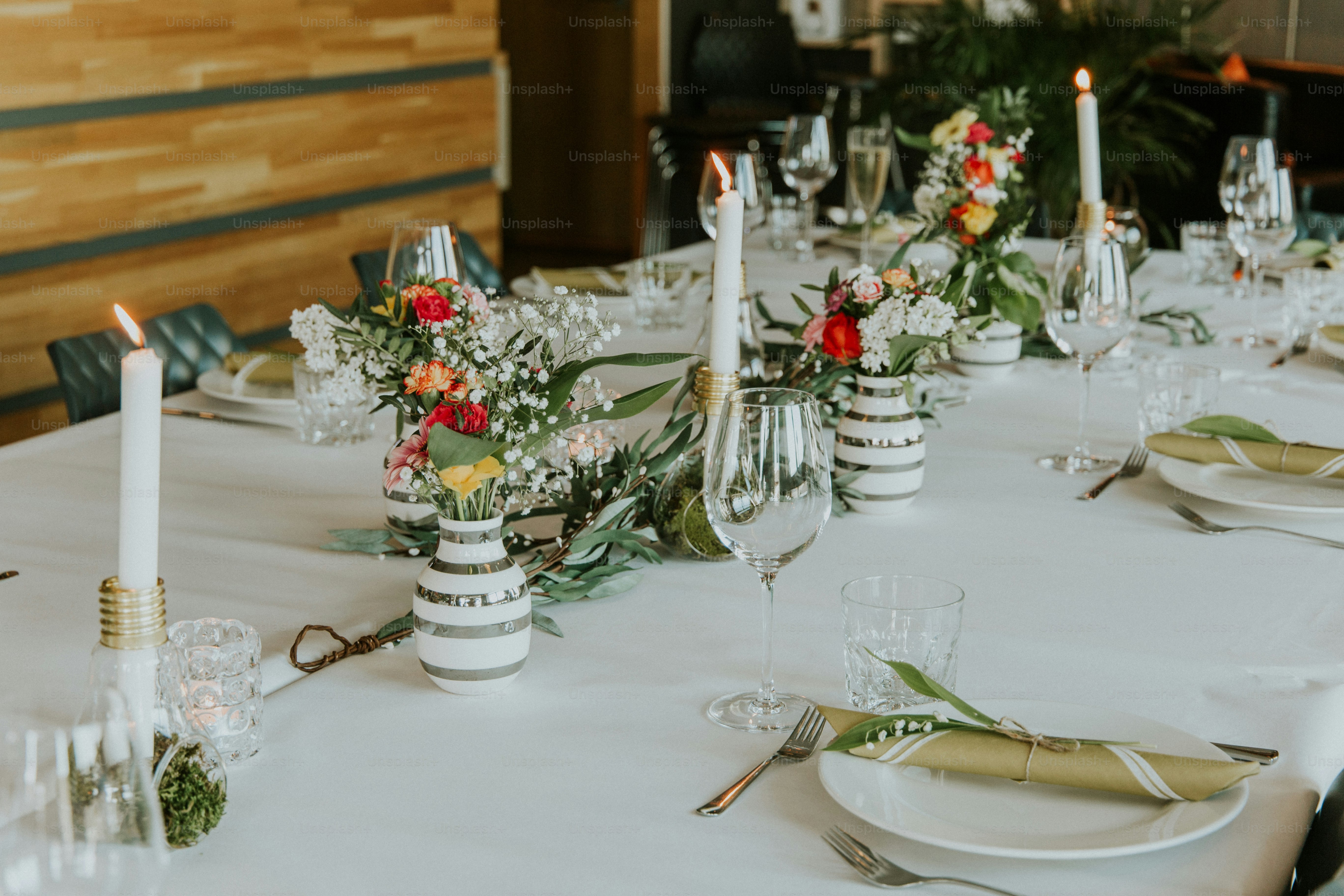 a table with a white table cloth and white candles