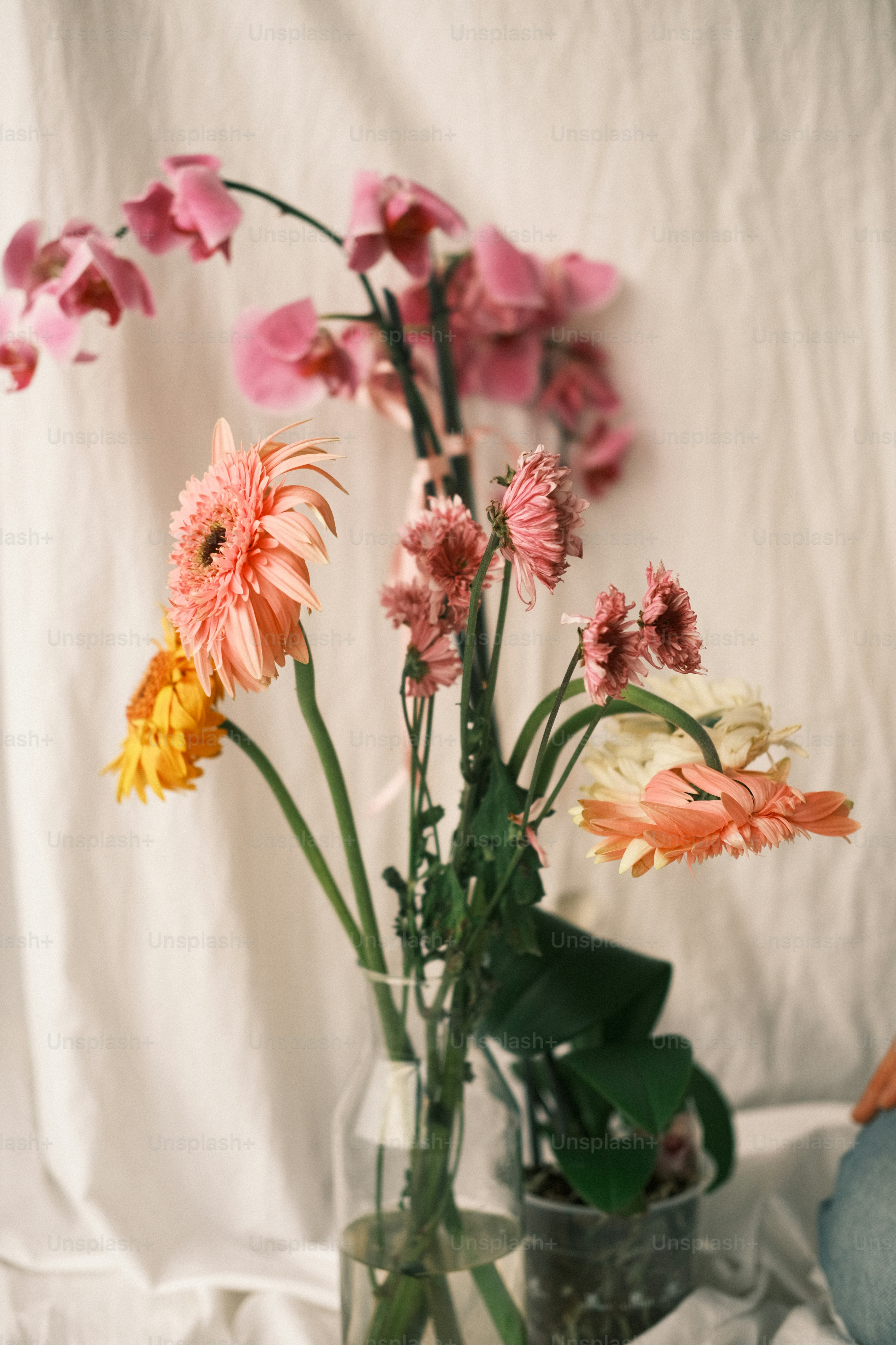a vase filled with lots of different colored flowers