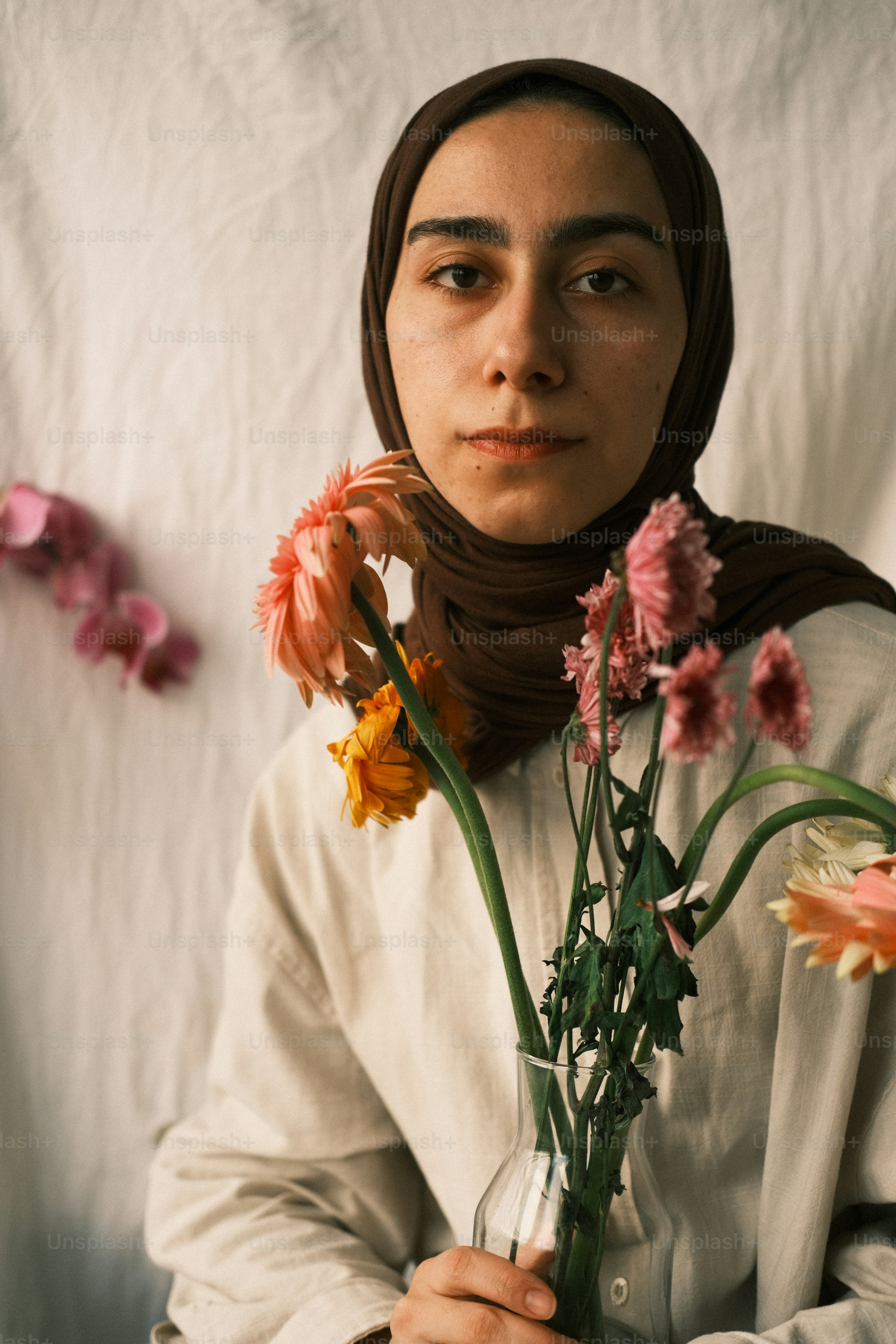a woman holding a vase with flowers in it