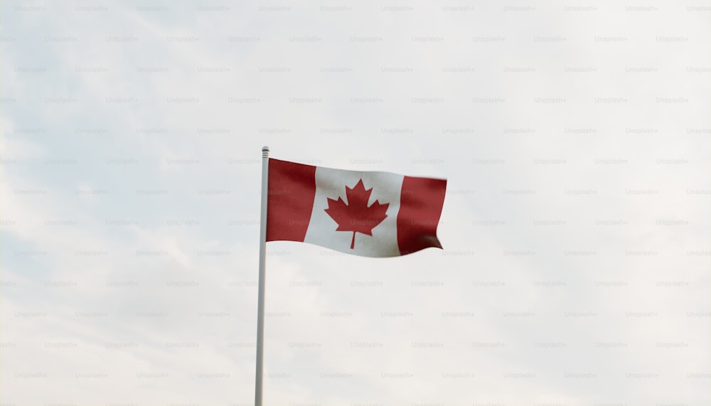 a canadian flag flying high in the sky