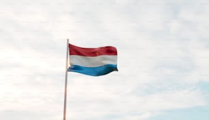 a flag flying in the wind on a cloudy day