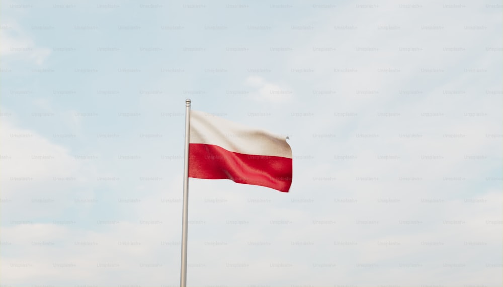 a flag flying in the wind with a blue sky in the background