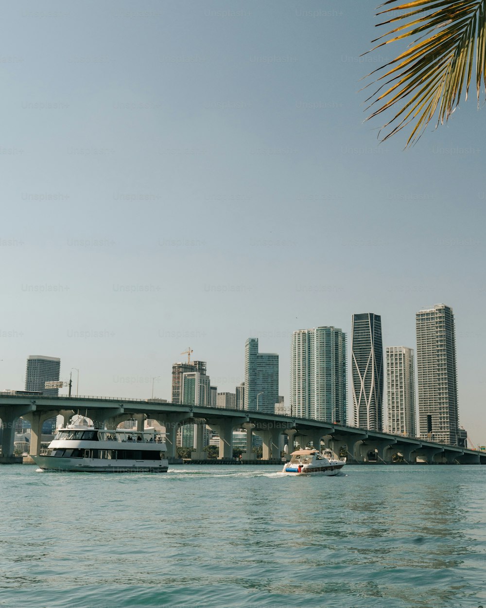 a boat traveling down a river next to a bridge