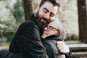 a man hugging a woman in a park