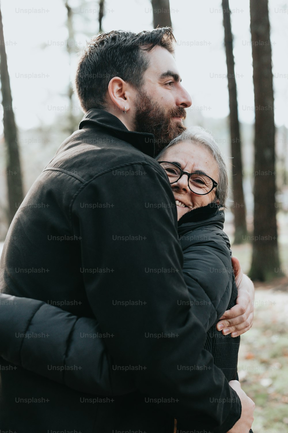 a man hugging a woman in the woods