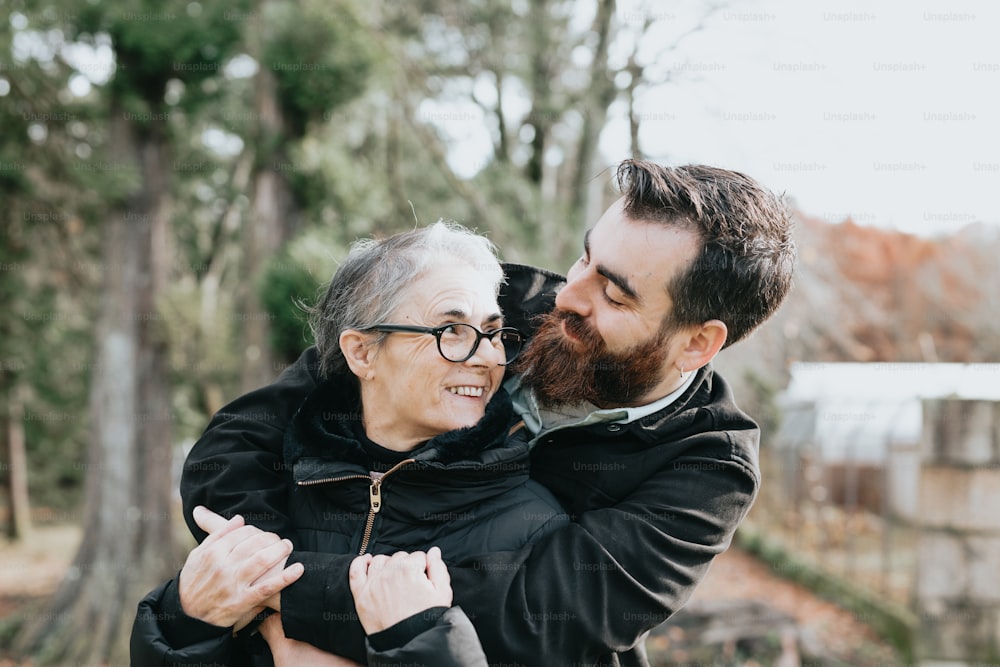 a man is hugging a woman in the park