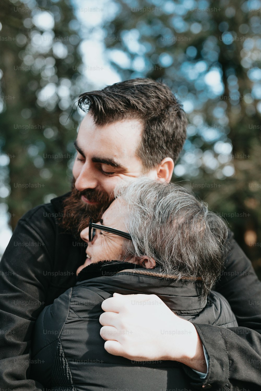 a man with a beard hugging a woman