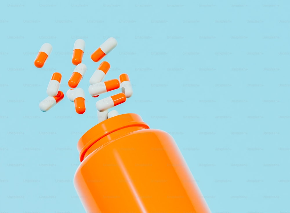 una bottiglia di pillola arancione con pillole che ne escono