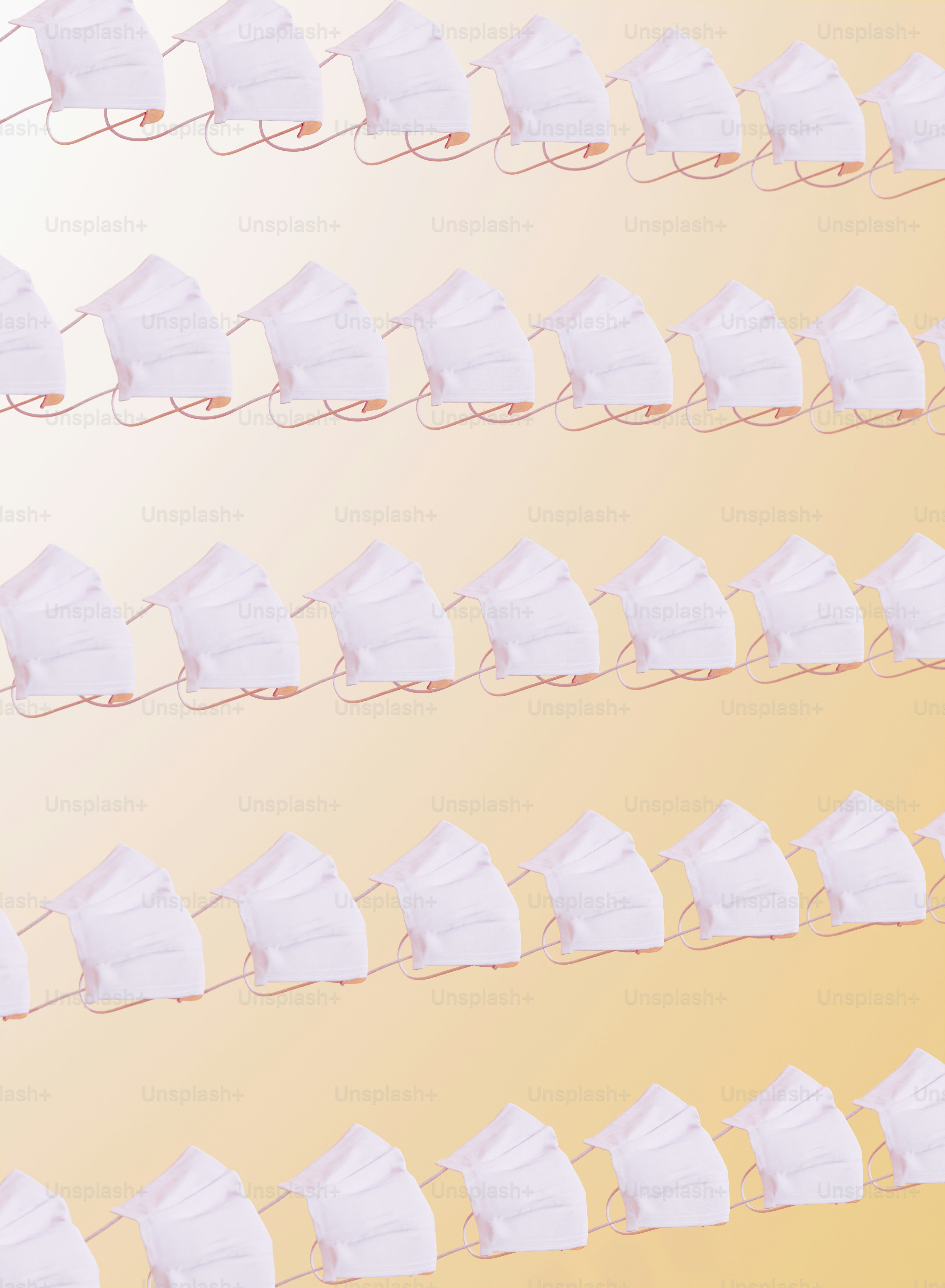 a row of white masks hanging from a wire
