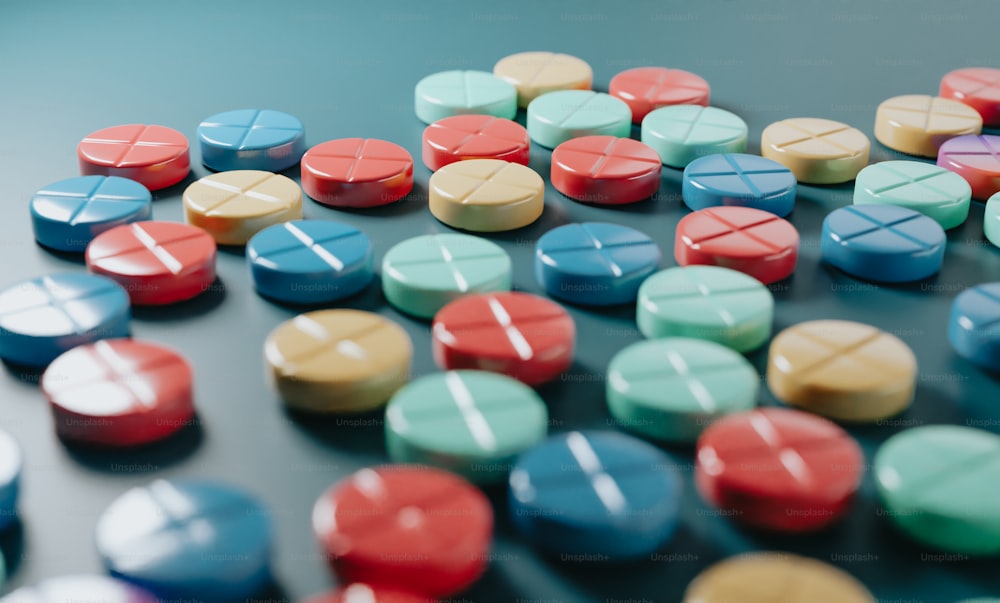 a bunch of colorful pills sitting on top of a table