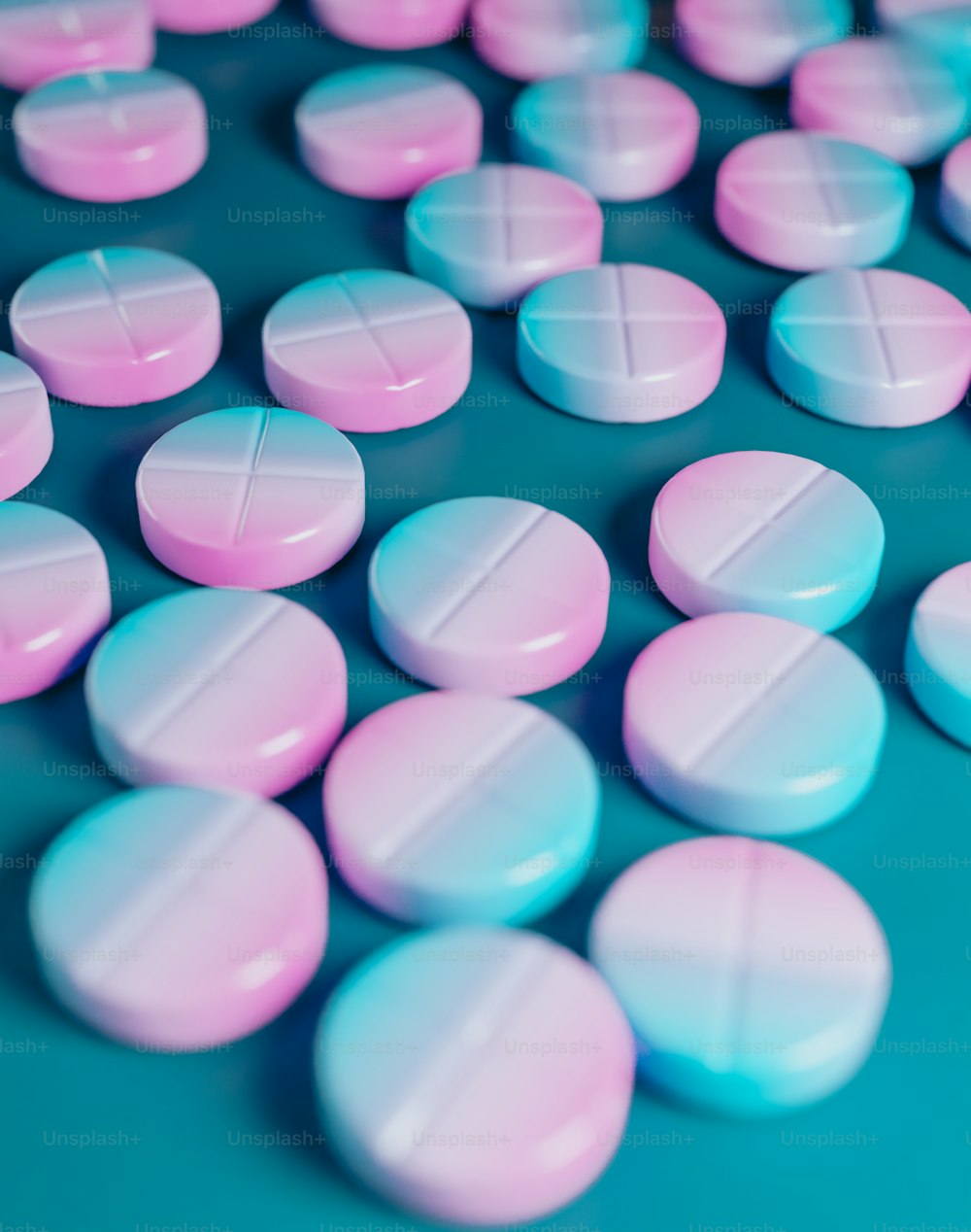 a close up of many pink and blue pills photo – Medication Image on Unsplash