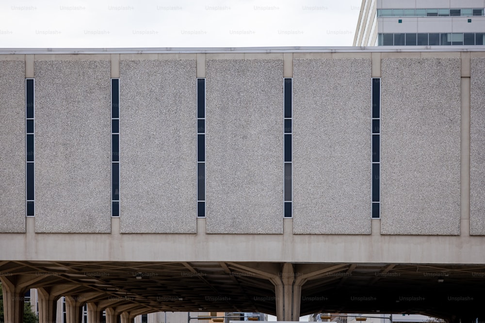 a bridge with a bus on it and a building in the background