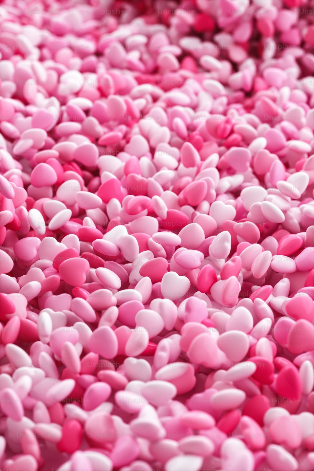a pile of pink and white hearts on a table