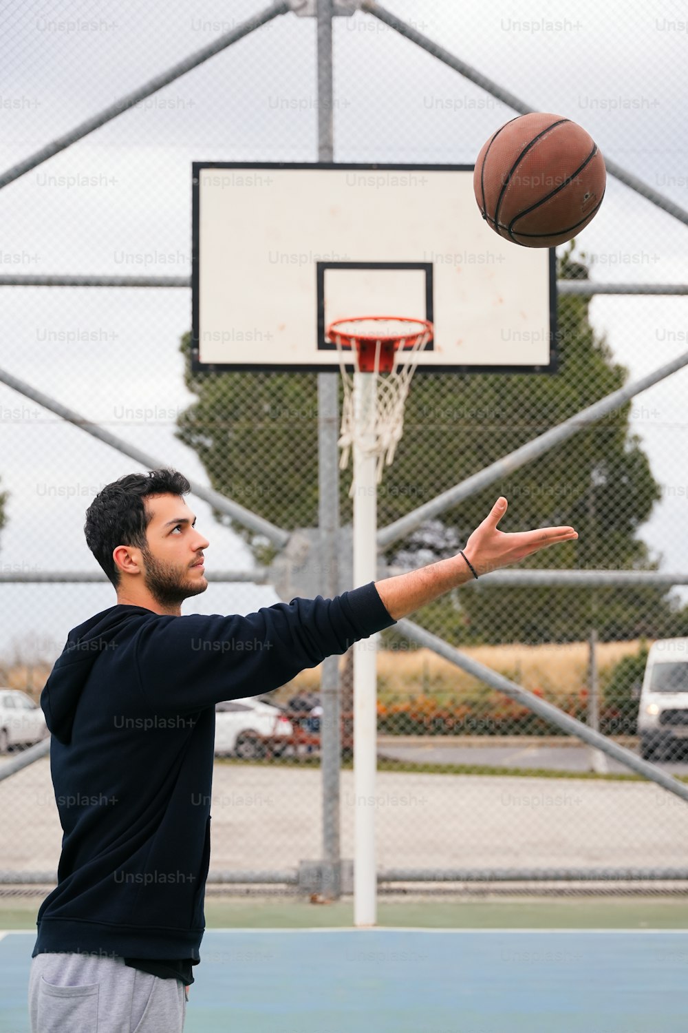 a man throwing a basketball into the air