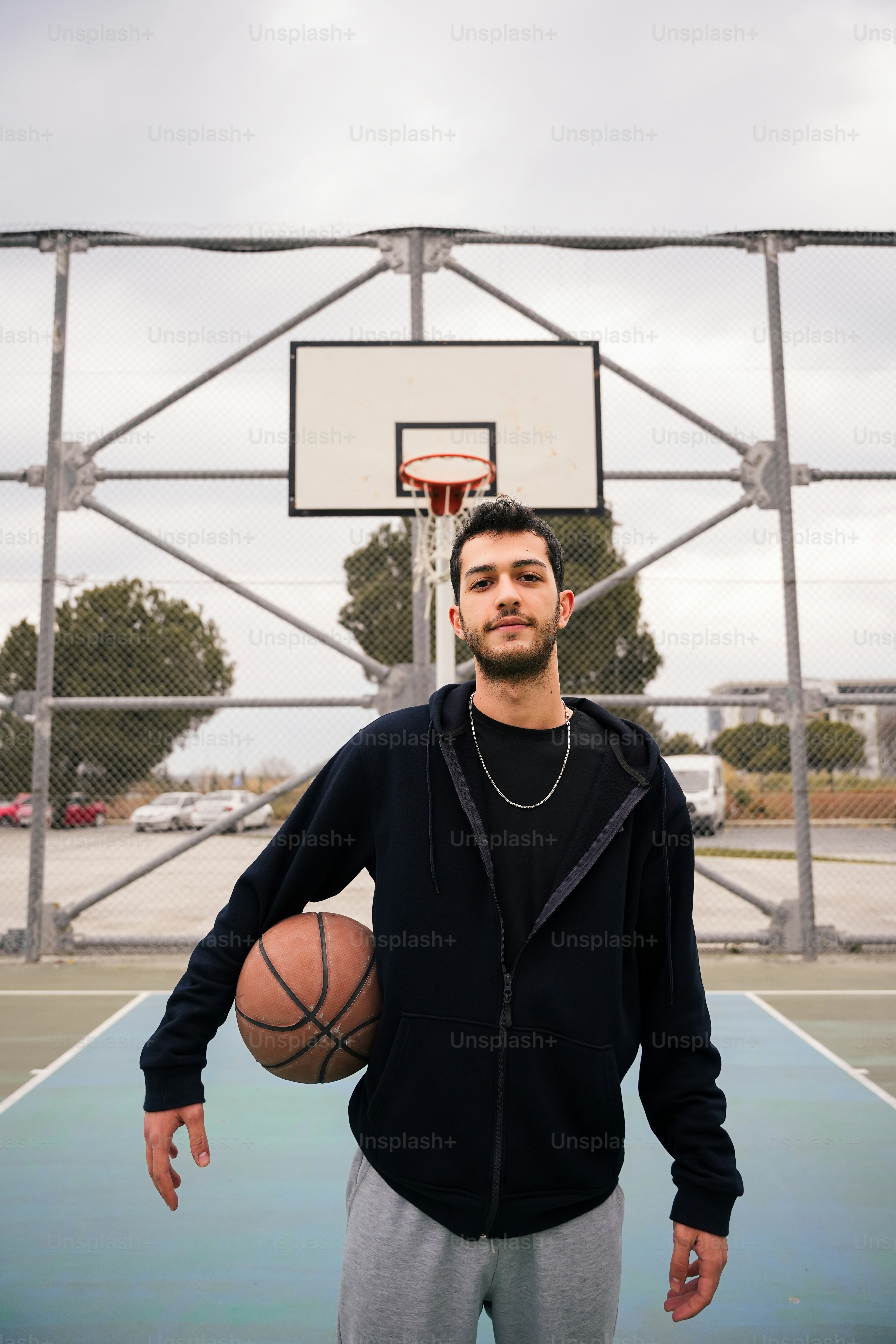 a man holding a basketball on a basketball court