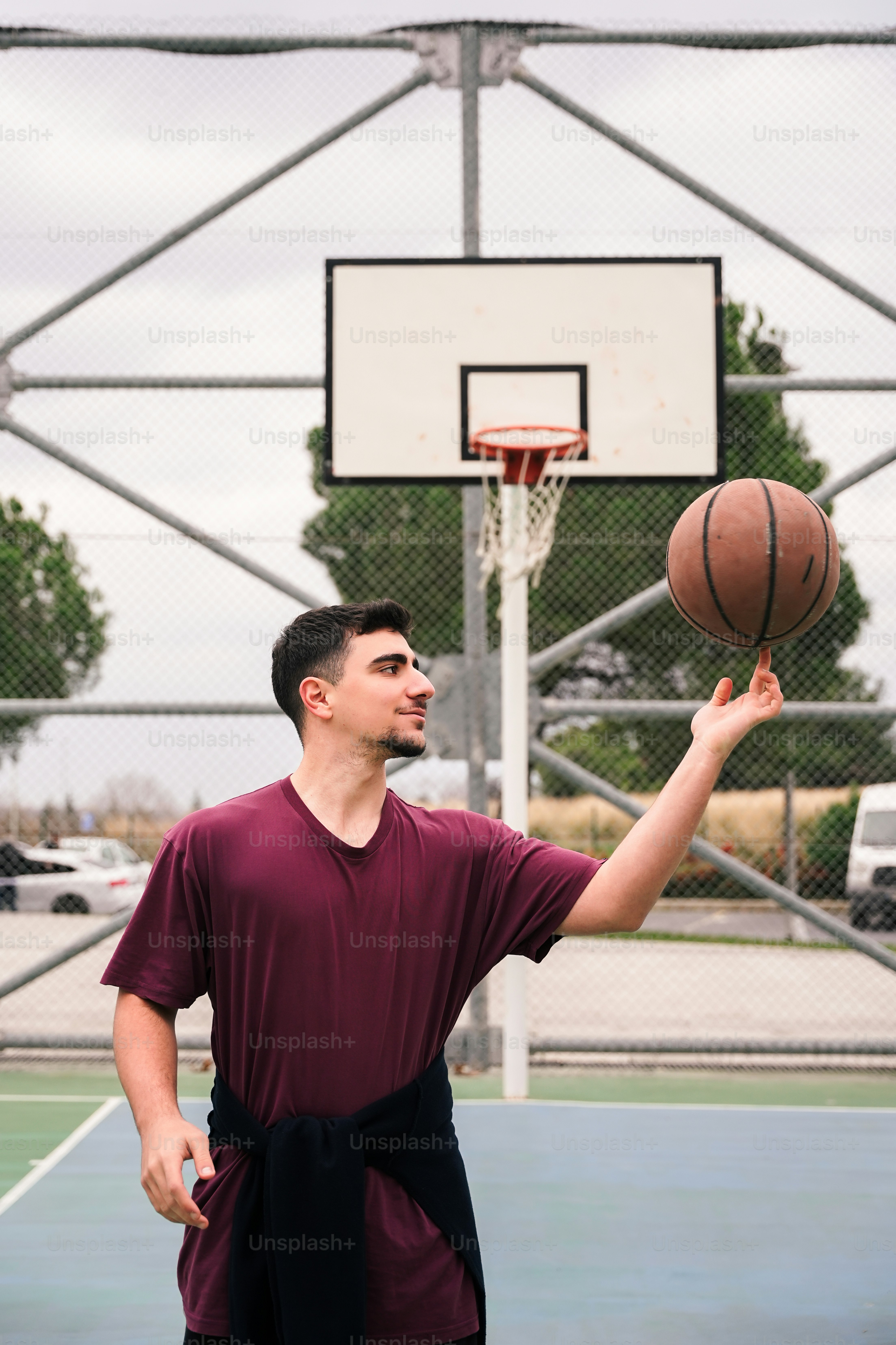 a man holding a basketball on a basketball court
