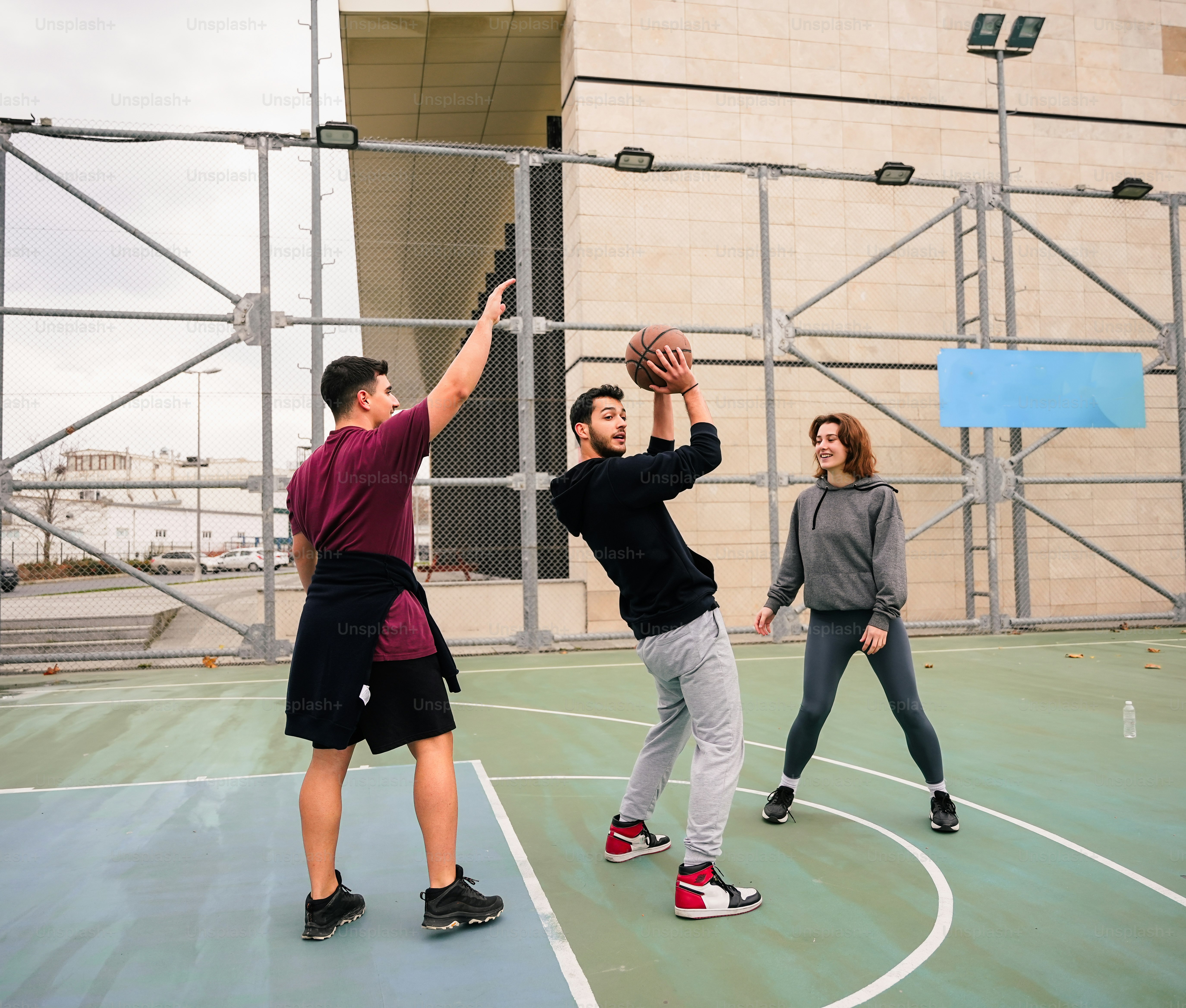 a group of young people playing a game of basketball