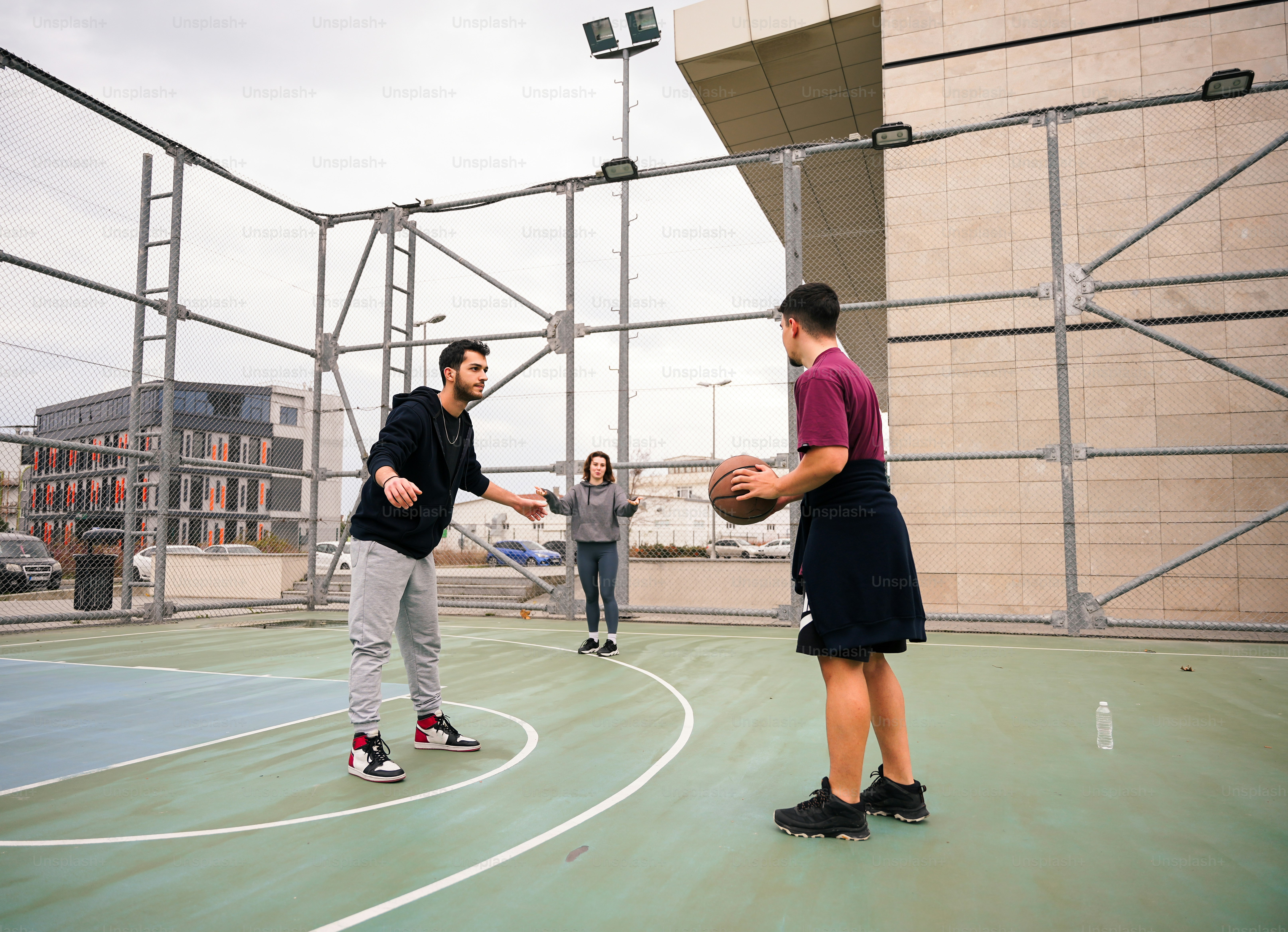 a man standing on a basketball court holding a basketball