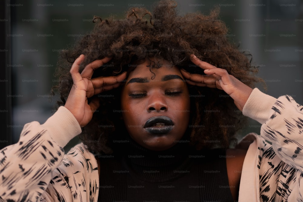 a woman with her hands on her head