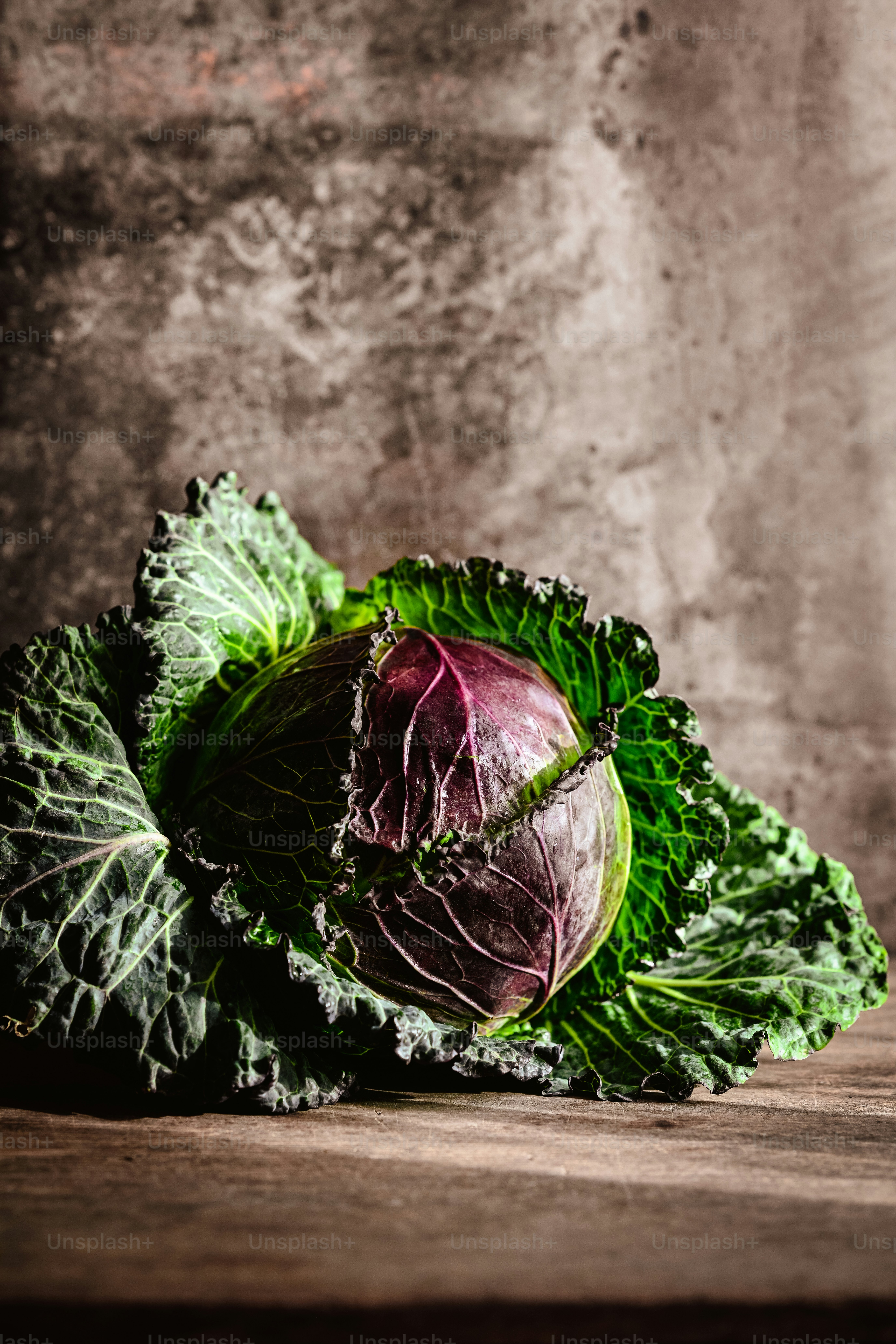 a head of lettuce sitting on top of a wooden table