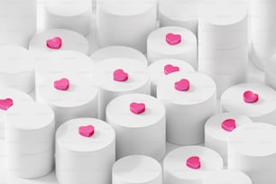 a bunch of white rolls with pink hearts on them