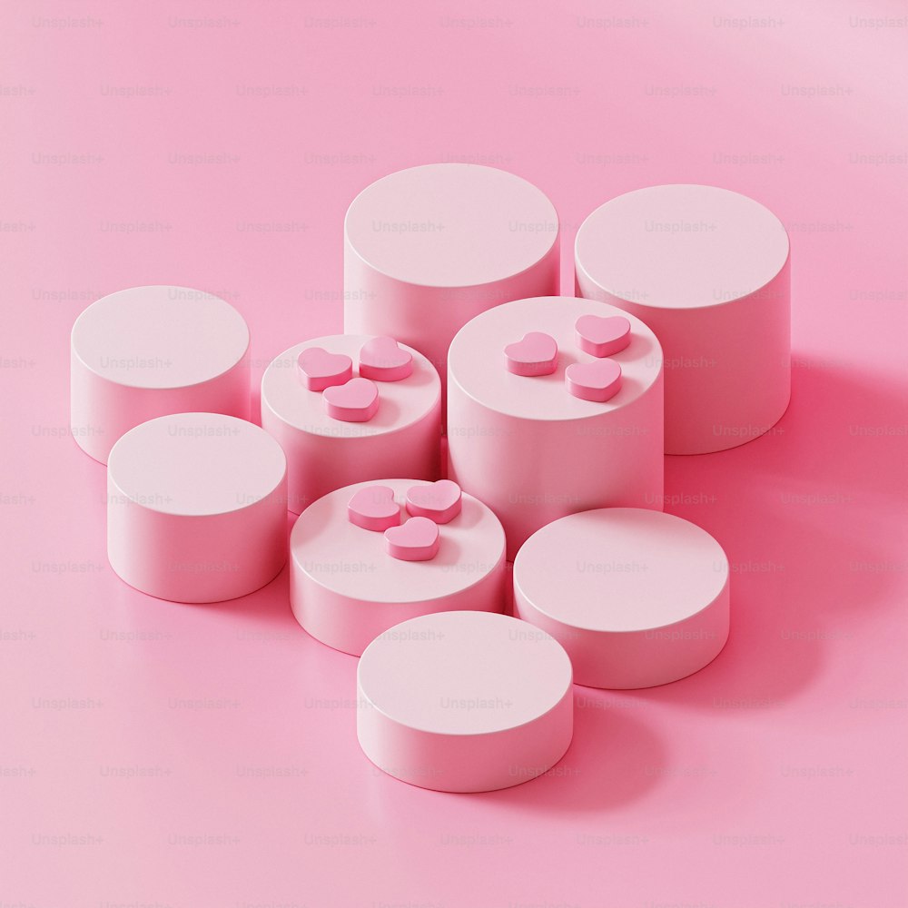eine Gruppe rosa und weißer runder Objekte auf rosa Hintergrund