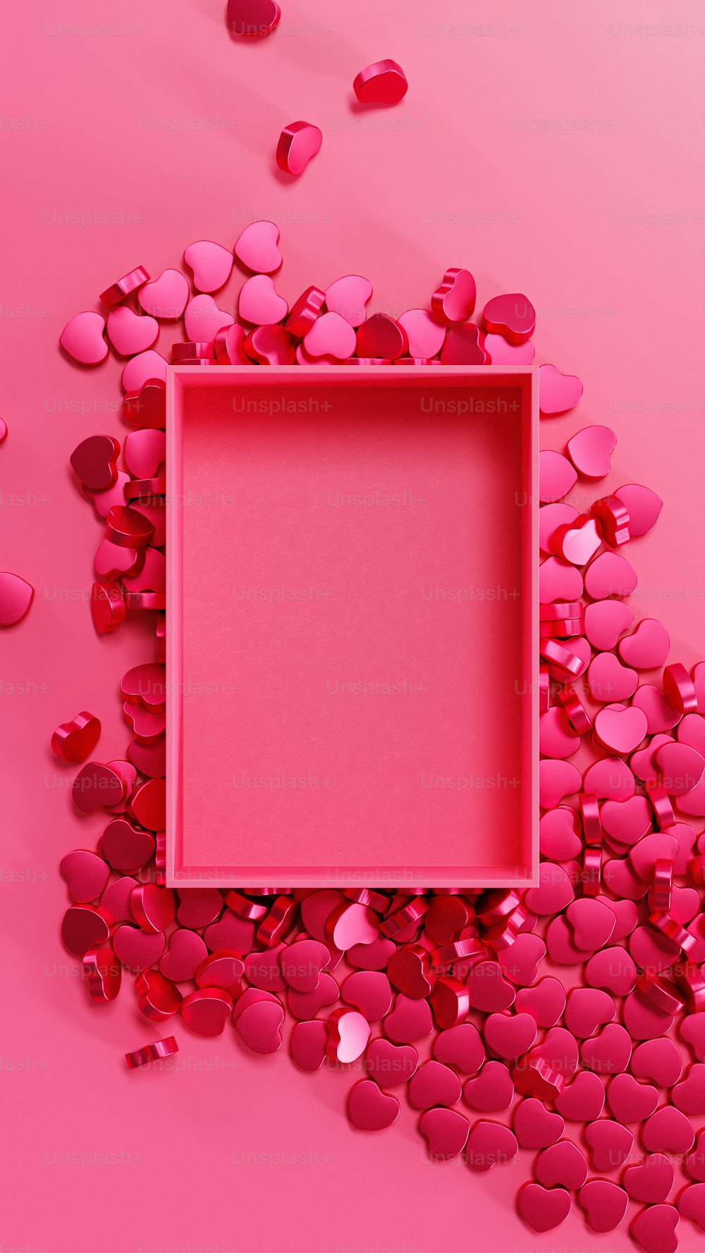 Ein rosa Rahmen, umgeben von Herzen auf rosa Hintergrund