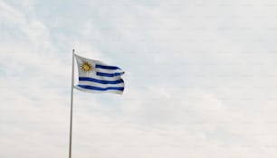 a flag flying in the wind on a cloudy day