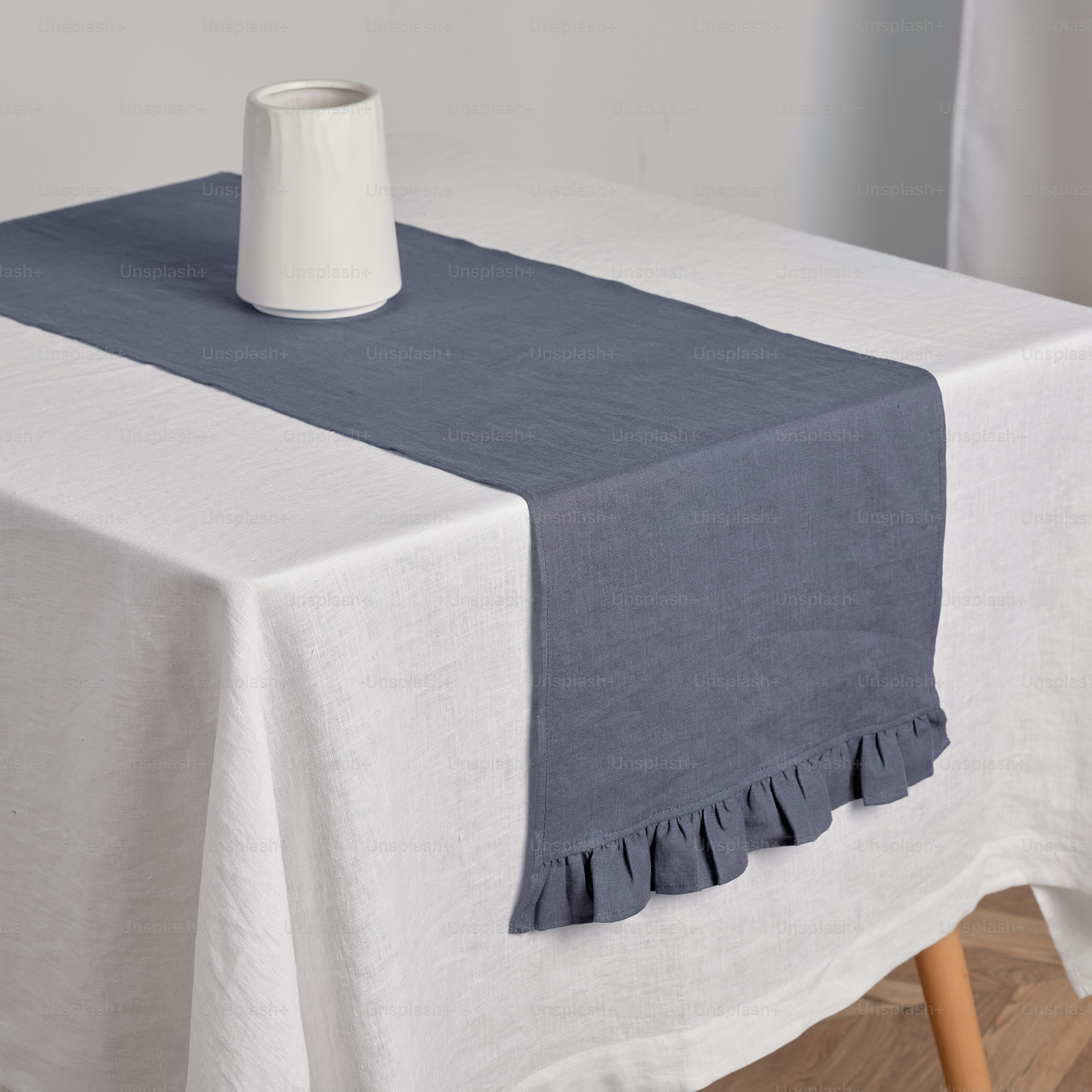 a white vase sitting on top of a table