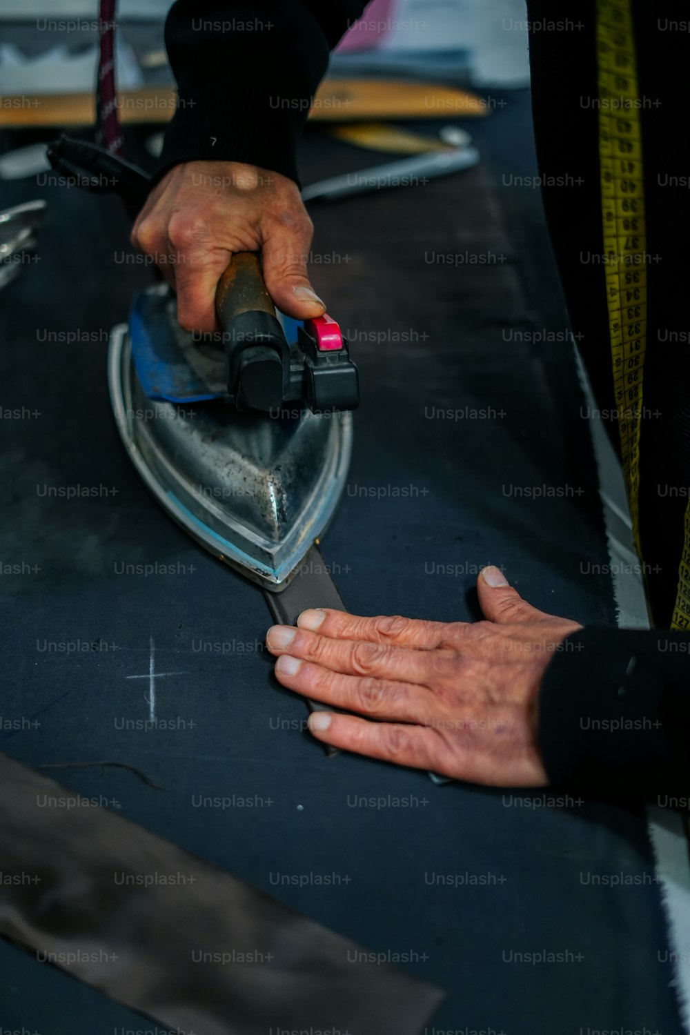 a person is using a hand sander on a piece of fabric