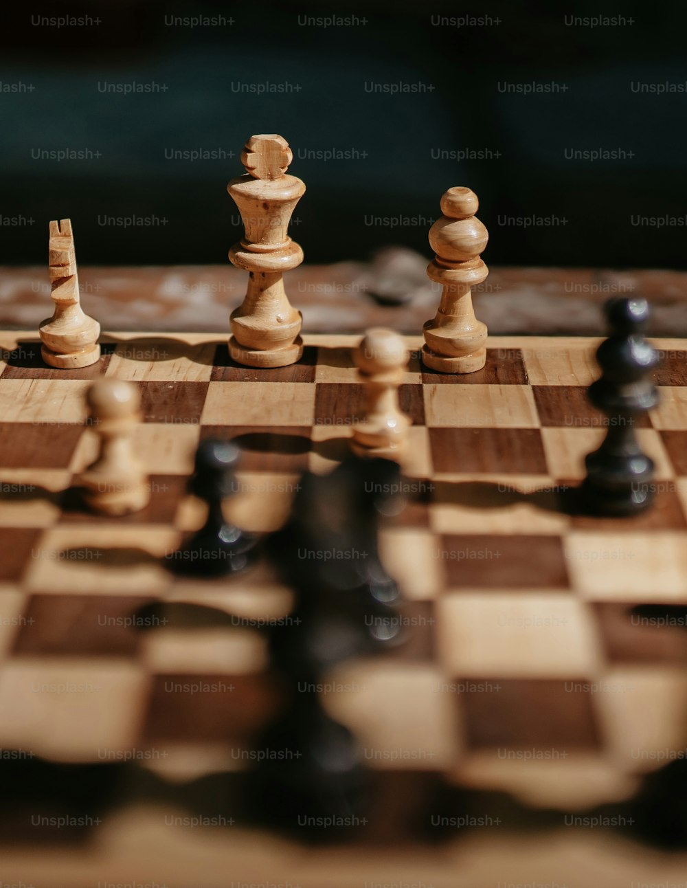 a close up of a chess board with pieces on it