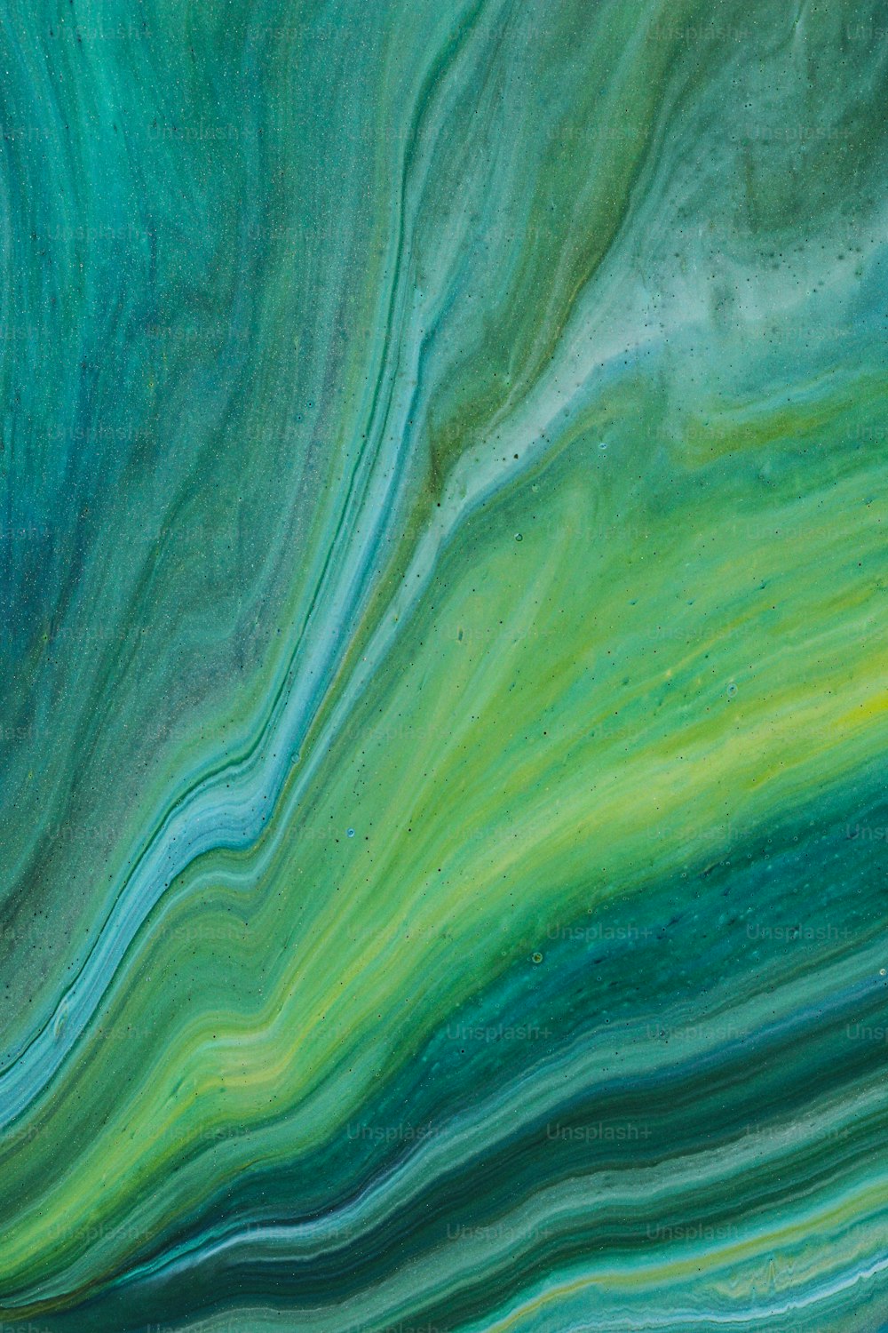 a close up of a green and blue marble